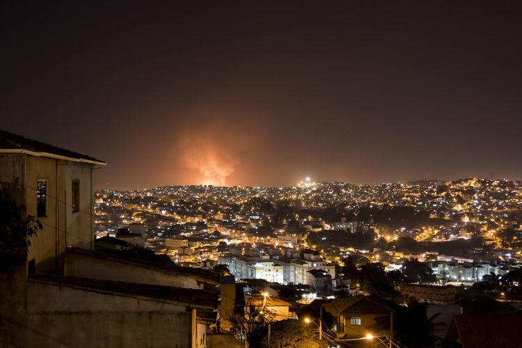 Fire in illuminated city at night