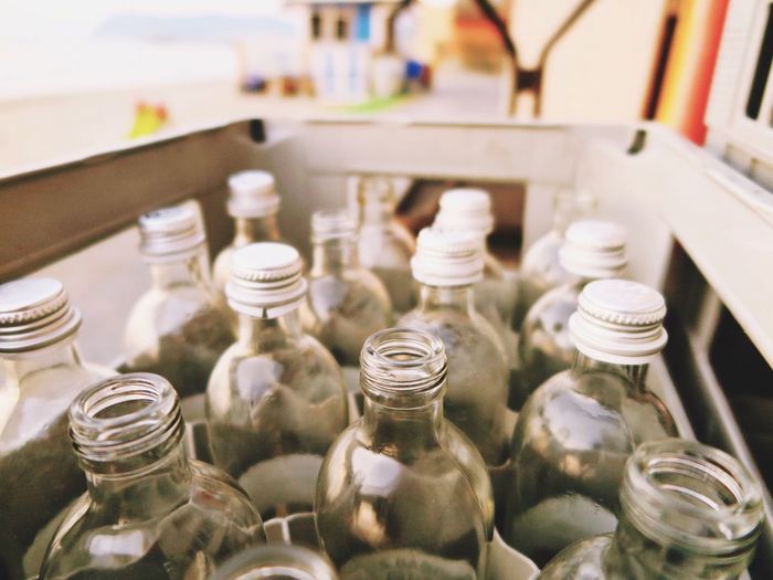 Close-up of glass bottles in crate