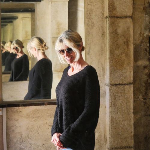 Portrait of young woman in sunglasses reflecting on mirrors