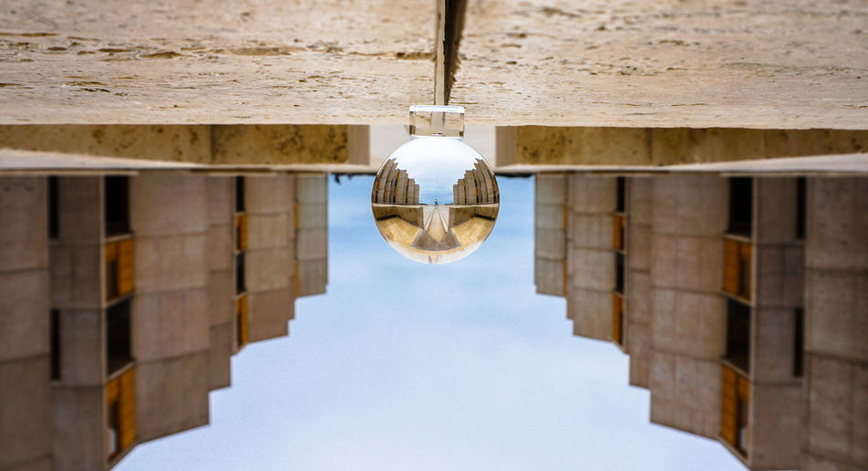 Low angle view of crystal ball with architecture 