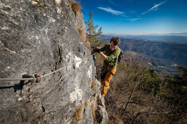 Man climbing rock on mountain