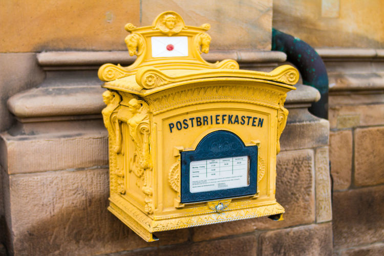 Yellow mailbox on wall