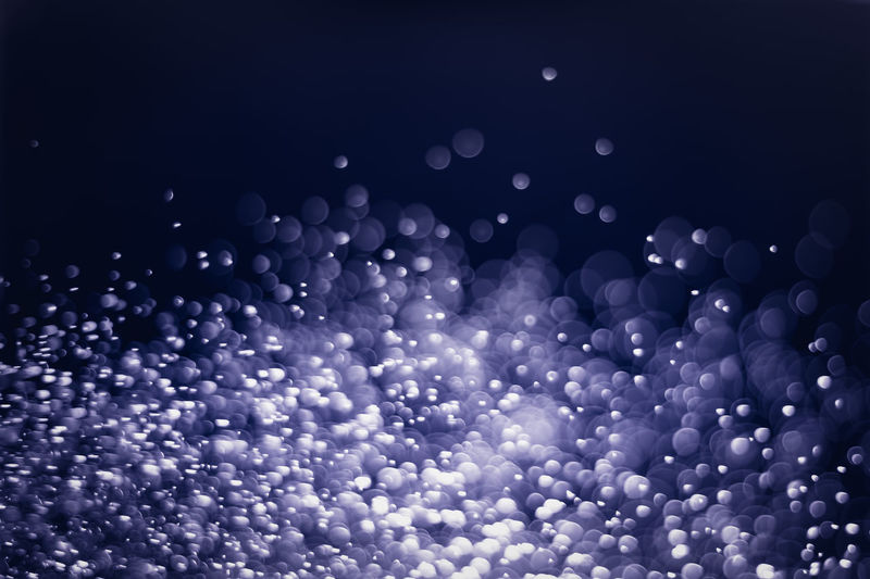 Defocused image of bubbles against blue sky