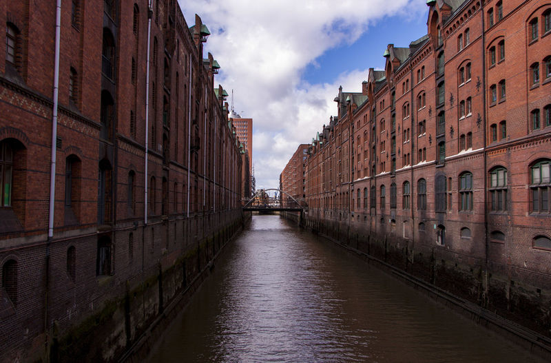 Canal amidst buildings at speicherstadt