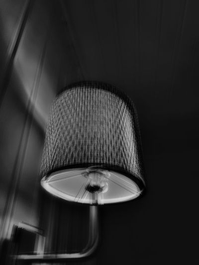Low angle view of illuminated electric lamp at home