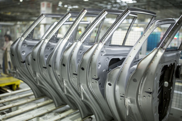 Modern automatized car production in a factory, row of car doors