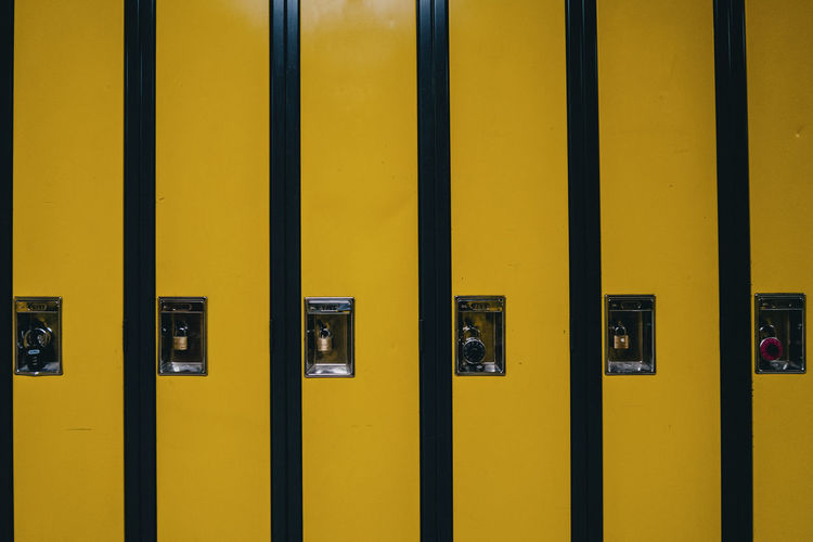 Closeup view of yellow high school lockers.