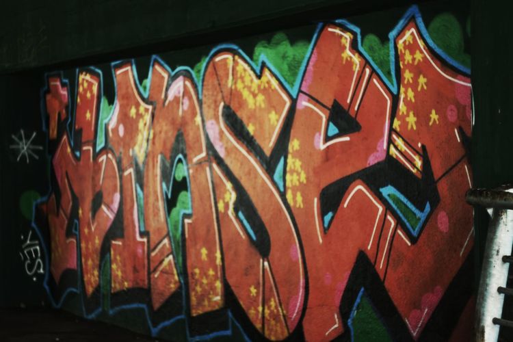 Close-up of graffiti on built structure