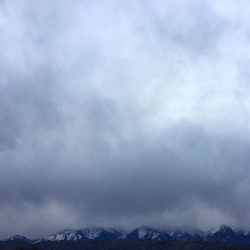 Low angle view of mountain against cloudy sky