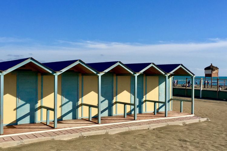 Wooden huts on sunny beach in italy
