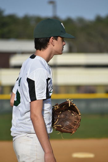 Side view of baseball player wearing gloves
