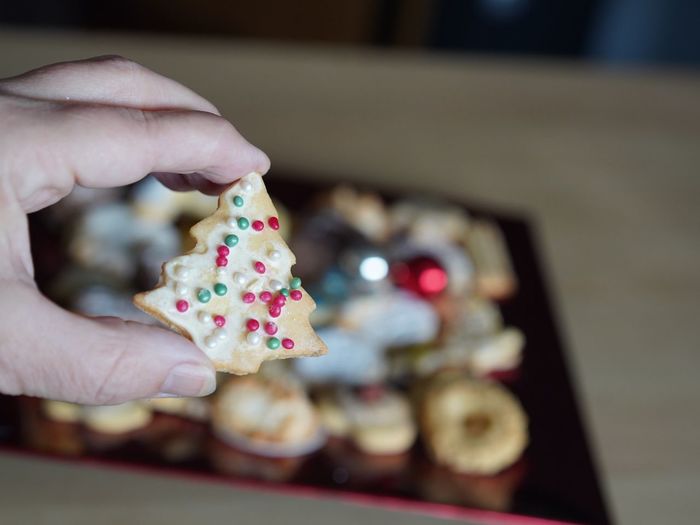 Fingers holding homemade christmas cookie