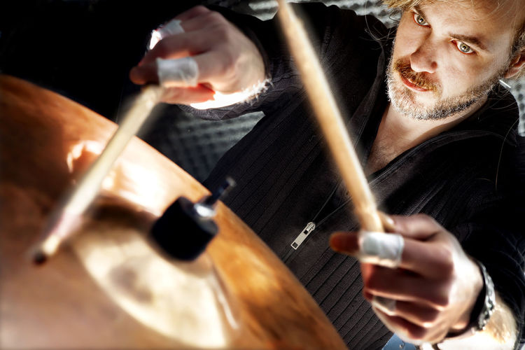 Close-up of man playing drum