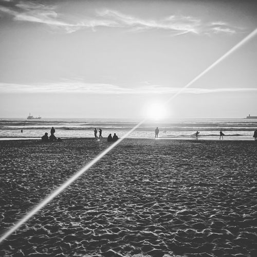 People on beach against sky