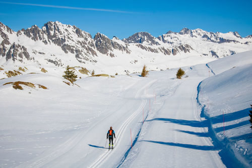 Rear view of man skiing on snow covered land