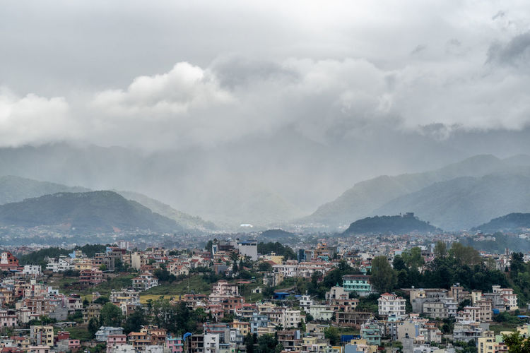 A view of the population density in city of kathmandu under a stormy sky.