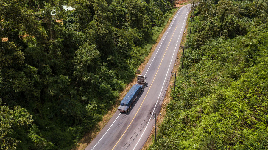 High angle view of highway amidst trees in forest