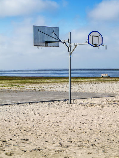 Side view of a two-sided street basketball hoop mast on the beach in east frisia