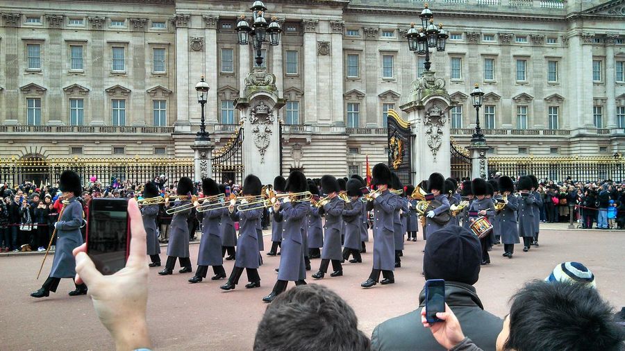 British royal guards walking in parade against buckingham palace