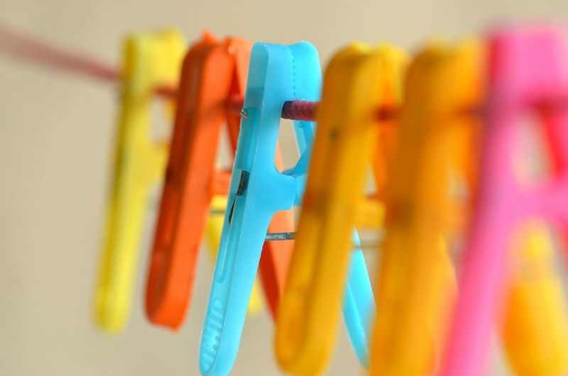Close-up of colorful clothespins on clothesline