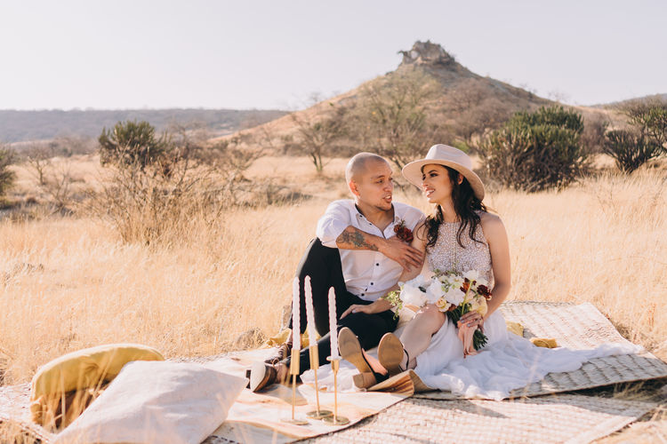 Couple sitting on land