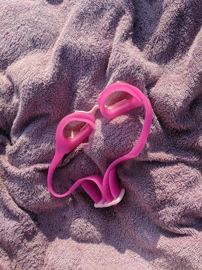 Close-up of swimming goggles on towel