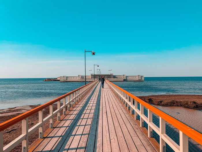 Pier over sea against sky