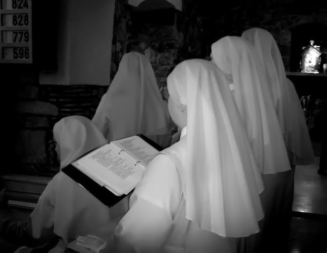 Nuns reading bible at church