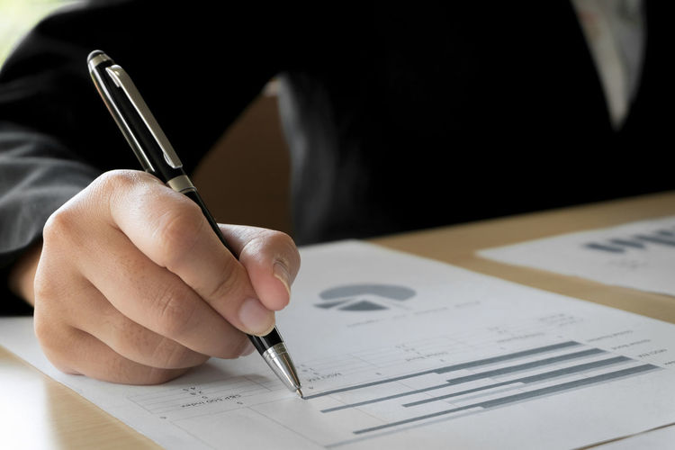 Midsection of business person working in office