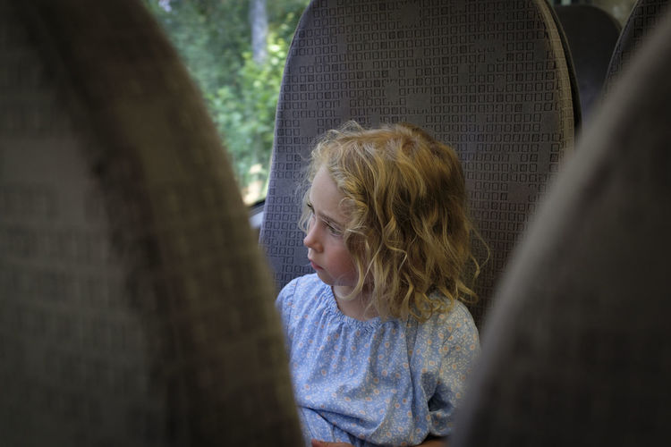 Portrait of a girl looking away on bus