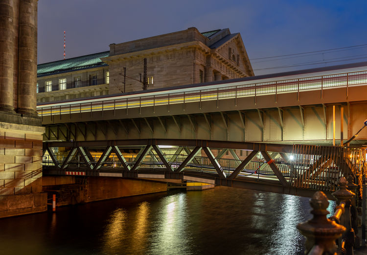 Low angle view of bridge over river against sky