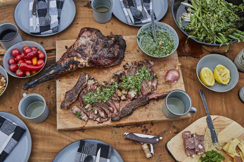 Summer barbecue spread with steak, venison and chimichurri