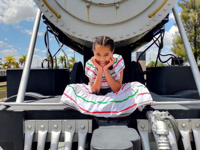 Happy little girl mexican sitting in train
