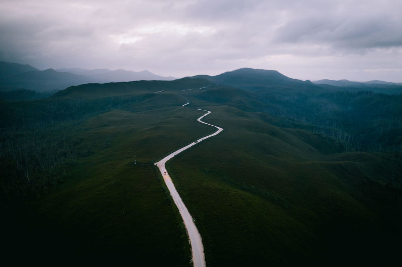 Aerial view of mountain road against cloudy sky