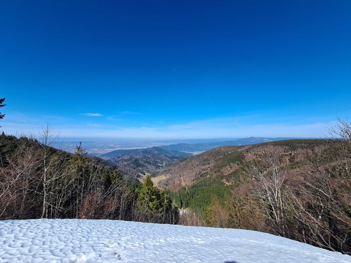 Scenic view of mountains against clear blue sky