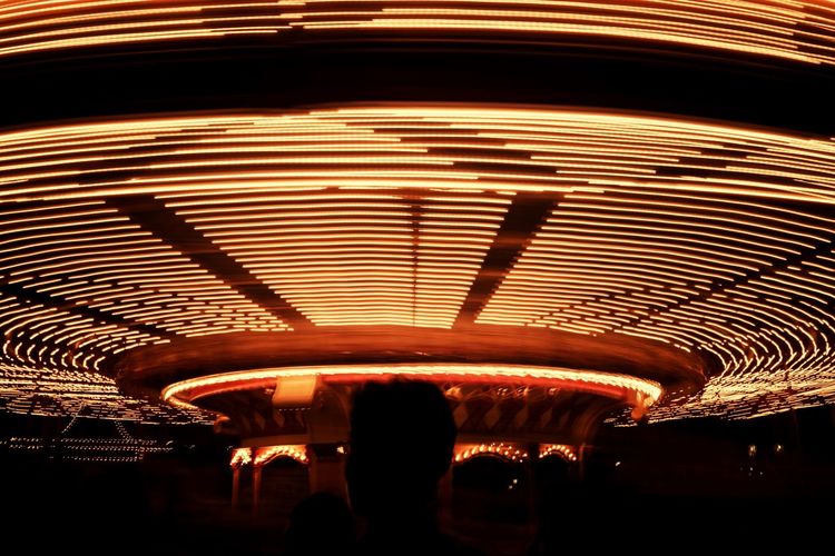 People at illuminated amusement park