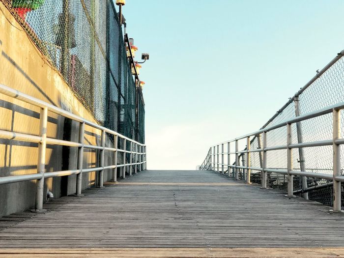 Footbridge against clear sky