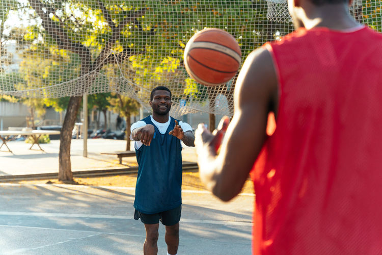 Rear view of man playing basketball