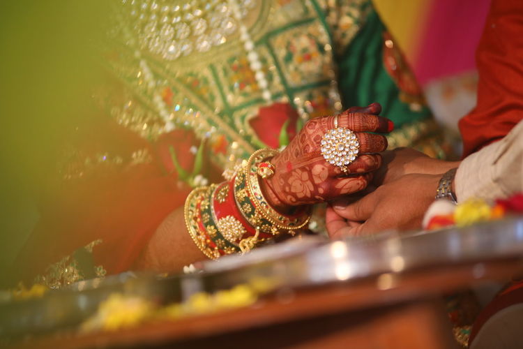 Midsection of couple during wedding ceremony