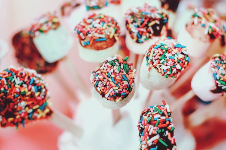 Bunch of white marshmallows with colorful sprinkle top
