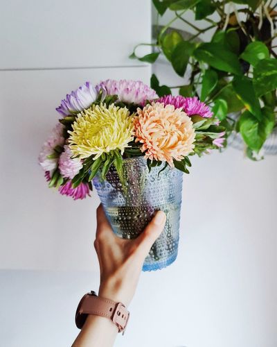 Close-up of hand holding bouquet of flower