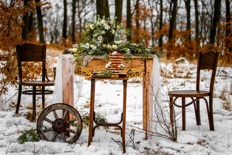 Decorated table against trees during winter