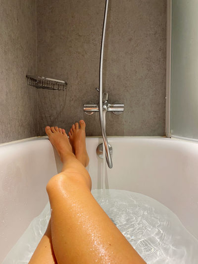 Female legs personal perspective relaxing in the bathtub