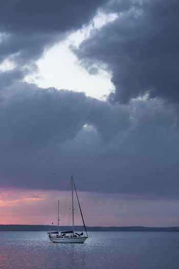 Sailboat sailing in sea against sky