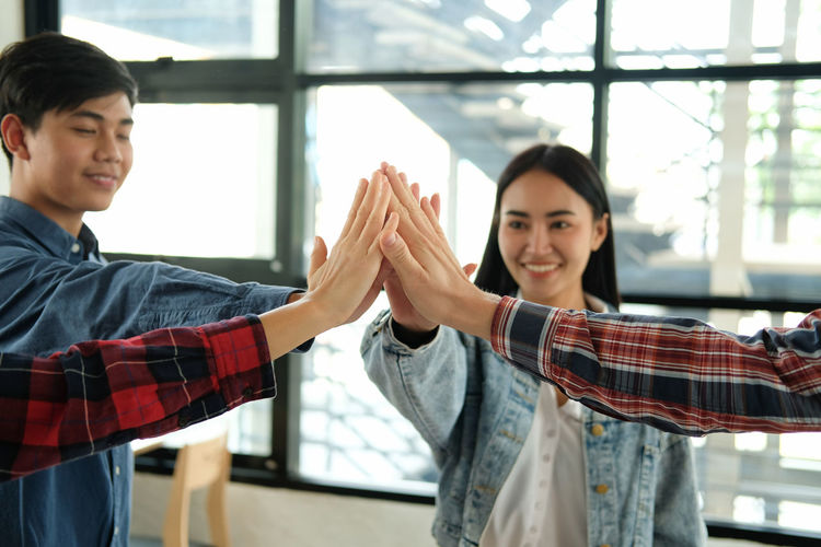 Happy coworker giving high-five in office