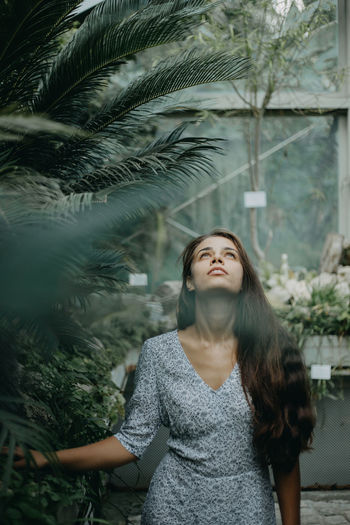 Front view of a young woman amidst plants