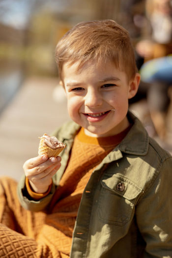 Portrait of cute boy holding ice cream cone