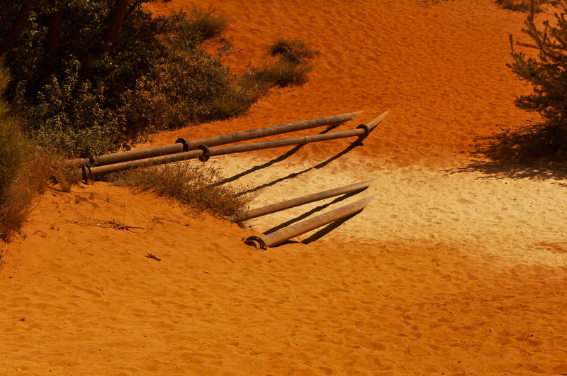 High angle view of deck chairs on sand