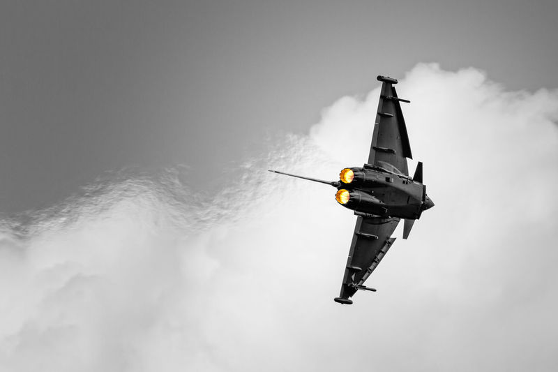Low angle view of airplane flying against sky