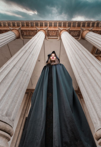 Portrait of woman standing against sky